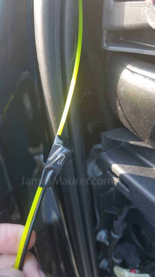 Black tape used to attach parking mode cable to fish wire for routing through GMC dash