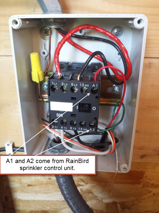 Multimeter testing voltage on irrigation pump relay A1 and A2 terminals