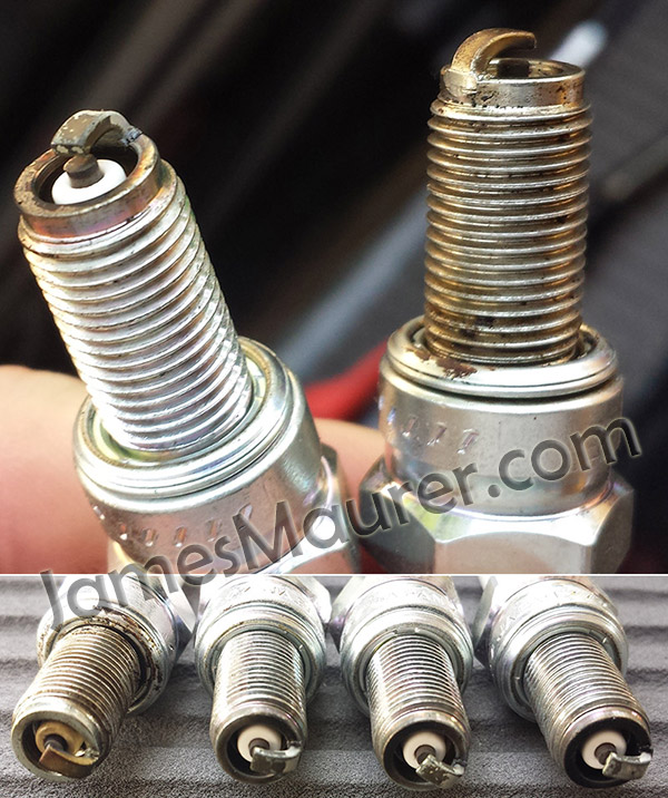Fouled spark plugs removed from a Yamaha Waverunner VX1100 - three look good, one is discolored